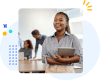 Woman smiling in an office setting while holding a tablet